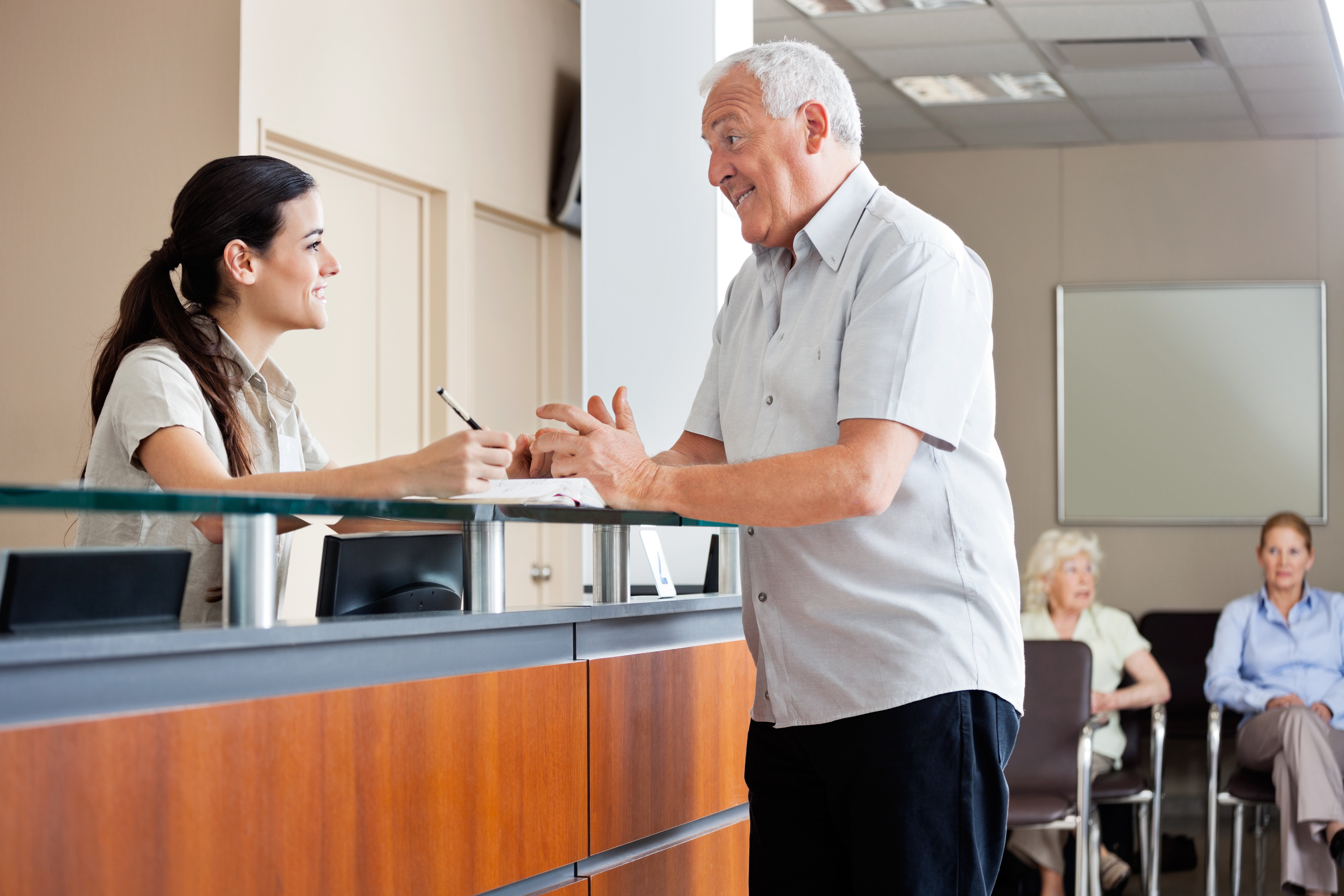 Man communicating with female receptionist