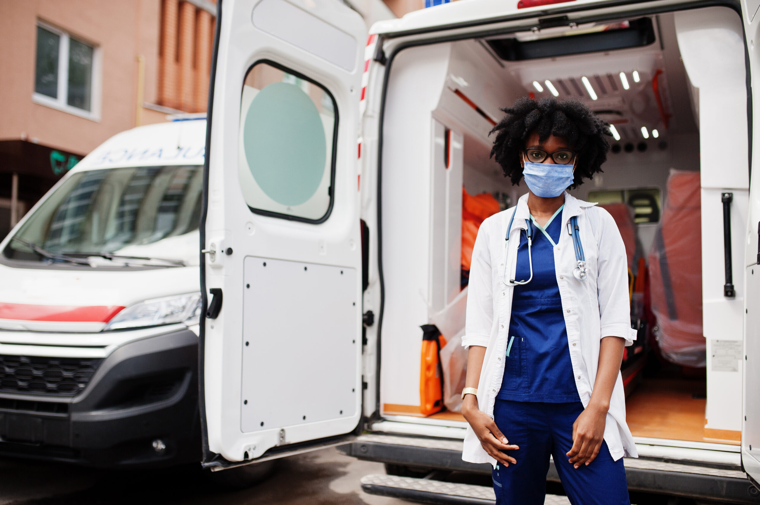 African american female paramedic in face protective medical mas