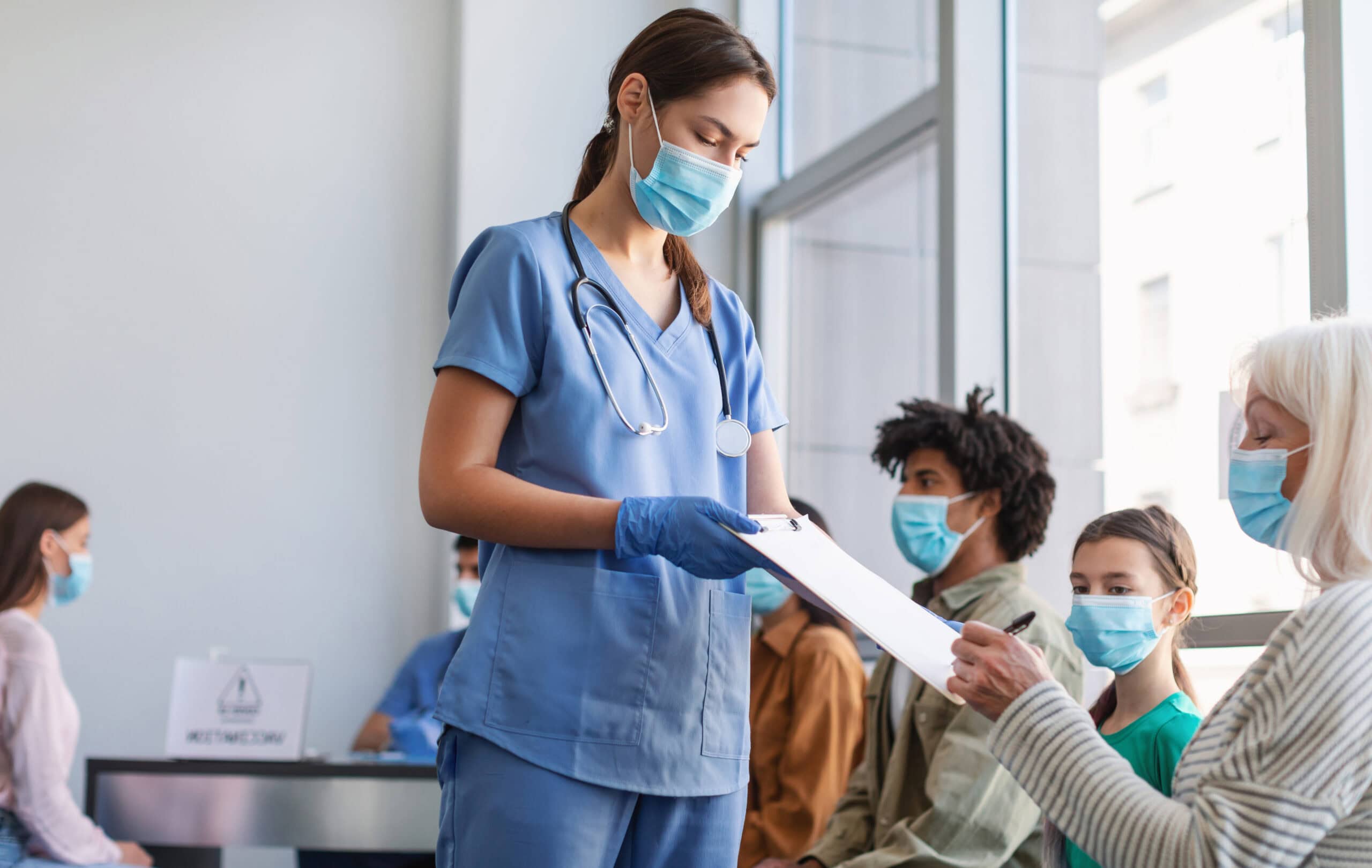 Senior patient lady signing papers with doctor in hospital