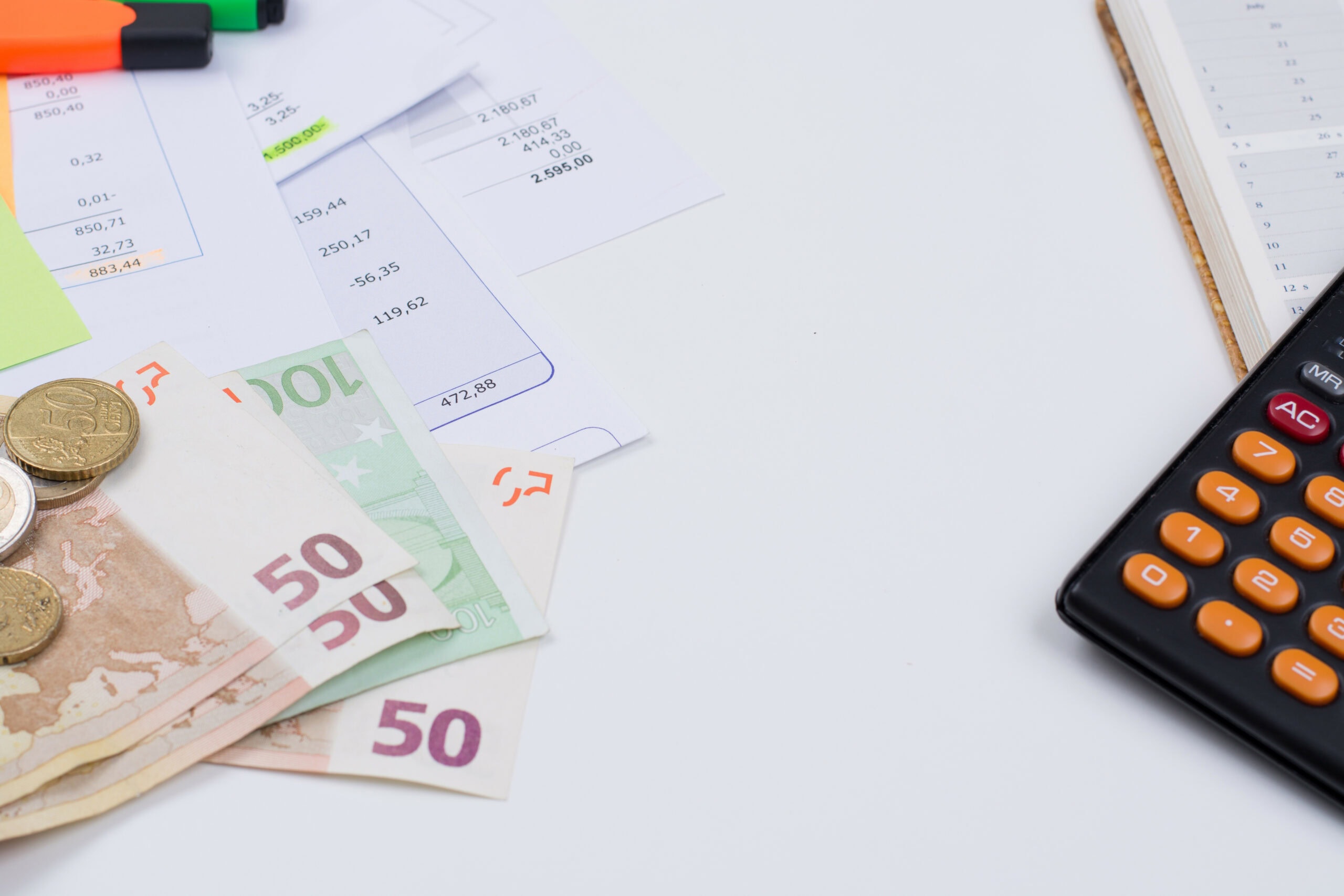 Utility or mortgage bills, calculator and euro banknote and coin